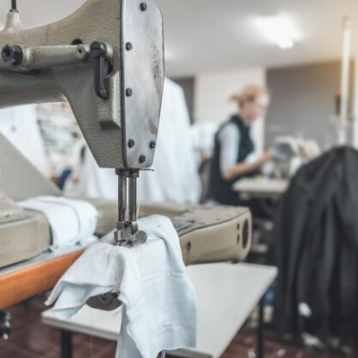 clothing-industry-workers-working-sewing-machines_1048944-2322075